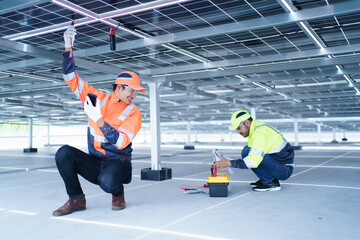 Electrical engineers are inspecting and installing a solar panels on the building rooftop.