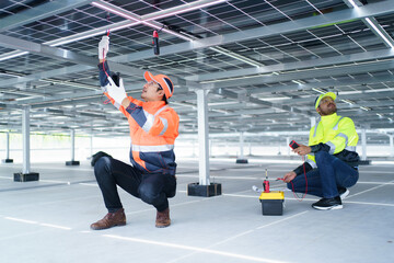 Electrical engineers are inspecting and installing a solar panels on the building rooftop.