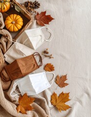 Basket of fall leaves with face mask and pair of masks on a linen background emphasizing autumn hues