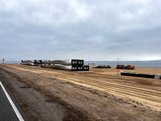 Rotor blades stored on the coast in National Park Reserve Paracas in Pisco Province, Peru.
The blades ready for building new wind turbines to create electrical energy.
Sustainable energy solution.