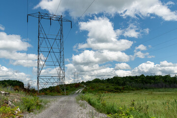 High voltage power lines on a summer cloudy day