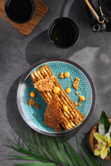 Slice of medovik cake, bright natural lighting, overhead dessert composition