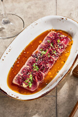 Tuna tataki with ponzu sauce, bright natural lighting, overhead composition for sushi restaurant menu