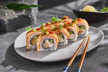 Seared salmon sushi roll with spicy sauce and shrimp, bright mood, overhead composition