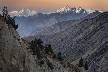 Snow-Capped Mountains Under a Warm Sunset Sky