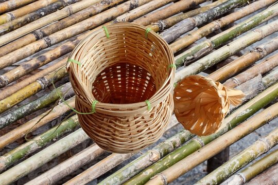 Thai wicker bamboo creel fisherman traps on the bamboo table background.