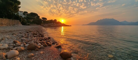 Beach Sunrise with Mountain and Pebble
