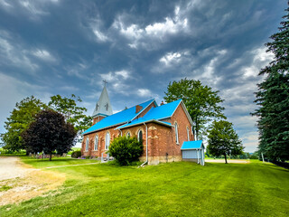 Fototapeta premium Experience the beauty and tradition of Mary of the Immaculate Conception Church in Alliston, a stunning red brick landmark since 1855