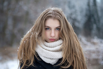 A winter portrait photograph of a young woman with long