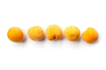 Fresh ripe apricots on a white background.