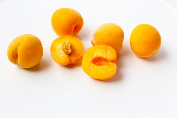 Fresh ripe apricots on a white background.