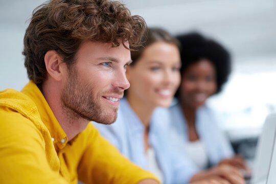 Diverse business team collaborating on digital marketing strategy using laptops and tablets in a bright office