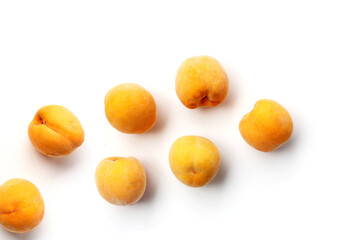 Fresh ripe apricots on a white background.