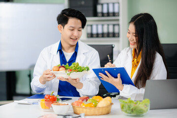 Doctors sharing fresh vegetables, promoting health and nutrition. Ideal for wellness, healthcare,...