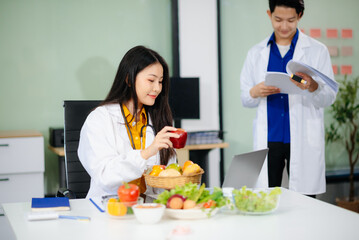 Doctors sharing fresh vegetables, promoting health and nutrition. Ideal for wellness, healthcare,...