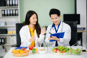 Doctors sharing fresh vegetables, promoting health and nutrition. Ideal for wellness, healthcare,...