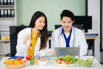Doctors sharing fresh vegetables, promoting health and nutrition. Ideal for wellness, healthcare,...