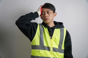 a male worker with a headache wearing a safety vest