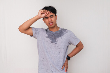 Portrait of a sweaty young Asian man showing tired facial expression and exhausted body gesture on...
