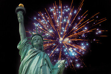 American Independence Day Statue of Liberty stands proudly as colorful fireworks light up night sky in New York City. © ungvar