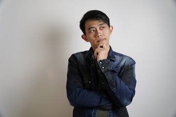 Thoughtful Asian Man with Hand on Chin