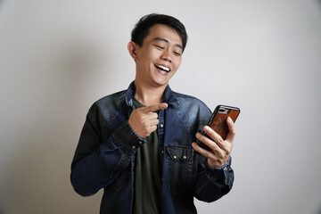 happy man and pointing at smartphone