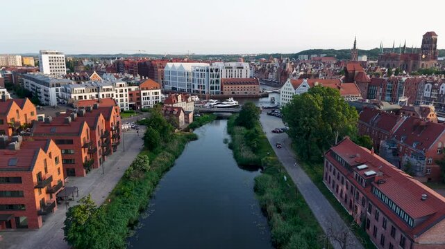 Aerial drone shot above Gdansk Moltlawa River, view of the city architecture and river, Poland. Slow motion