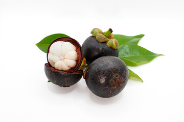 Fresh mangosteens, one perfectly peeled to reveal its pristine white pulp, arranged with green leaves on a white background.