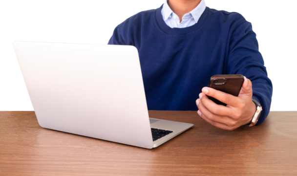 man using mobile phone and laptop