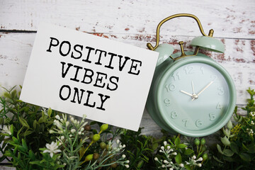 Positive vibes only text message motivational and inspiration quote top view on wooden background
