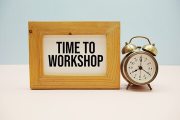 Time To Workshop text with alarm clock on blue and pink background