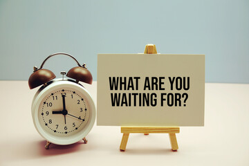 What are your waiting for? text on paper card with alarm clock on pink background