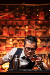 Bartender is pouring whiskey into a glass a customer's glass.