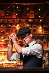 Bartender is pouring whiskey into a glass a customer's glass.