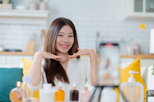 Young attractive asian woman beauty blogger or vlogger,influencer share story selfie blog skincare vlog.Asia Gen Z influencer vlog apply face skin care make on video shooting and live streaming