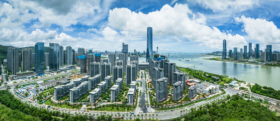 Wide panoramic of a rapidly developing coastal city with new residential apartments under...