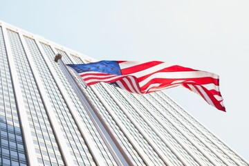 American flag and skyscraper