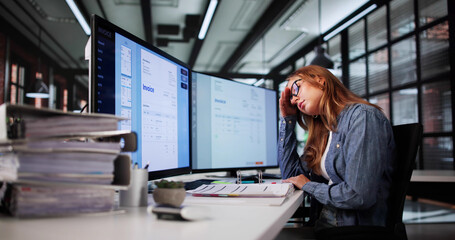 Overwhelmed Female Accountant Stressed With Multiple Invoices On PC Screen