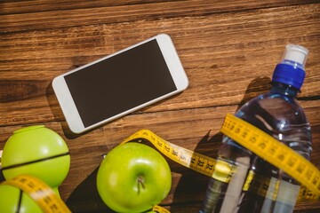 High angle view of apples and mobile phone on table