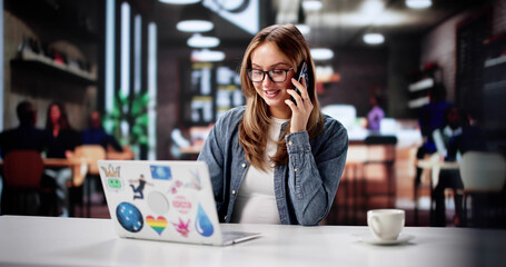 Businesswoman In Coffee Shop Taking Online Meetings