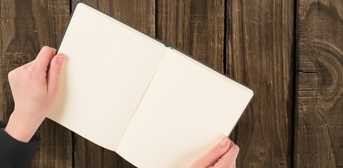 Overhead view of hand holding book