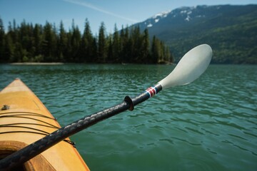 Oar in kayak over lake against mountain