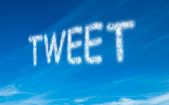 Fototapeta Tweet written in white in sky
