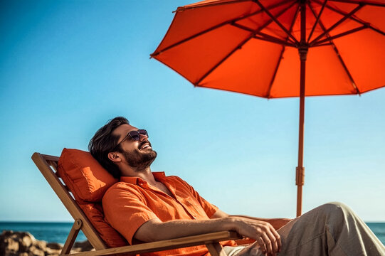 A smiling man with sunglasses and an orange shirt reclines on a wooden beach chair He is shaded by a vibrant orange umbrella against a clear blue sky and the ocean - Powered by Adobe