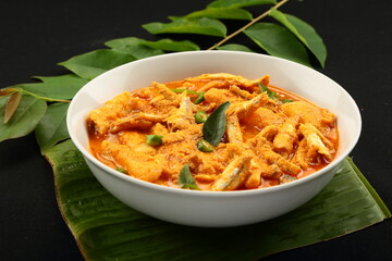 Kerala anchovy fish curry, cooked in coconut milk and green mango.