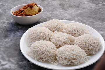 Traditional breakfast from Kerala -  idiyappam served with egg roast, steamed string hoppers. 