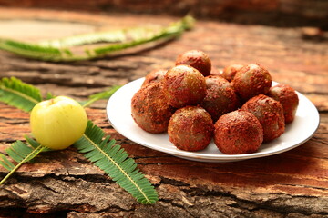 Homemade spicy  gooseberry pickle - Amla Achar- Indian recipes background. 