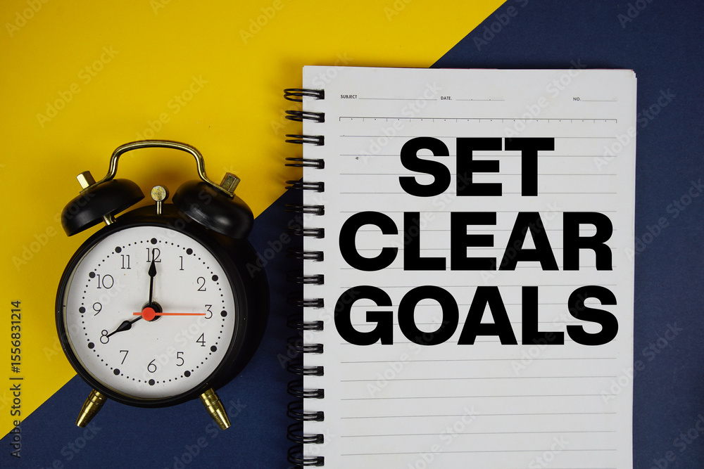 Poster set clear goals text written on notepad with alarm clock on yellow background
