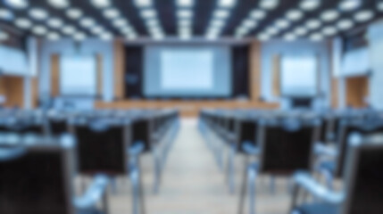 Blurred Auditorium background. Interior of professional lecture presentation room. Defocused corporate event seminar. Empty conference hall with row of chairs. Business convention center expo fair