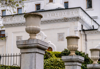 Stone vases on a pedestal in the park.